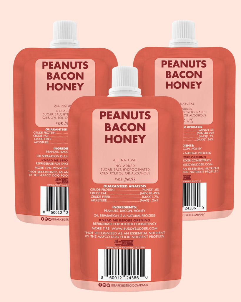 Three red squeeze packs of Bangin Bacon Buddy Budder dog peanut butter with peanuts, bacon, and honey, labeled 100% all natural and made in the USA.