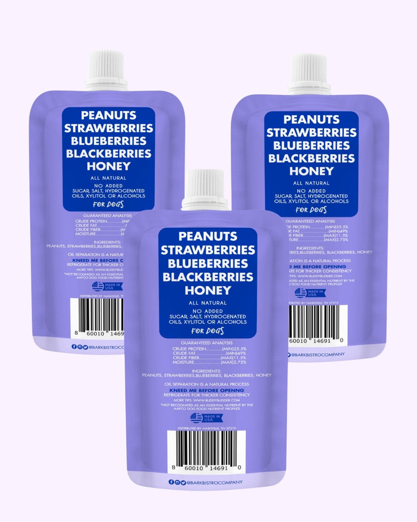 Three blue squeeze packs of Superberry Snoot Buddy Budder dog peanut butter with peanuts, strawberries, blueberries, blackberries, and honey, all natural, made in USA.